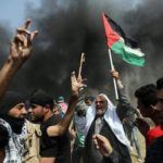 Palestinian demonstrators take part in a protest demanding the right to return to their homeland, at the Israel-Gaza border, in the southern Gaza Strip